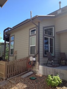 exterior radon mitigation system installed on the side of a home