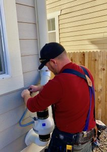 John Cardos owner of American Radon LLC installs a radon mitigation system in Westminster, CO