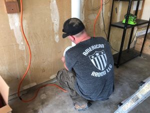 john cardos of american radon at work installing radon mitigation in windsor