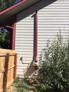 custom painted radon mitigation system to match the look of the home in windsor, co